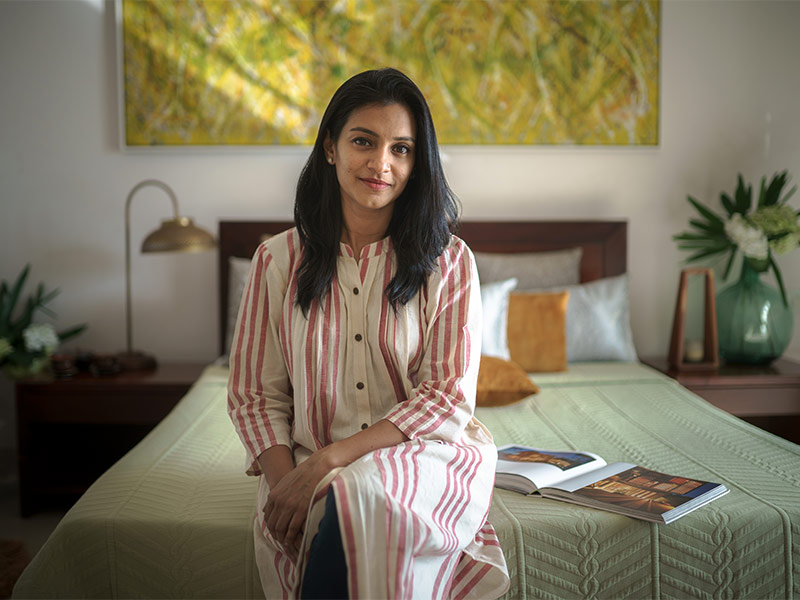 Ria Varghese sitting in her guest bedroom - Beautiful Homes